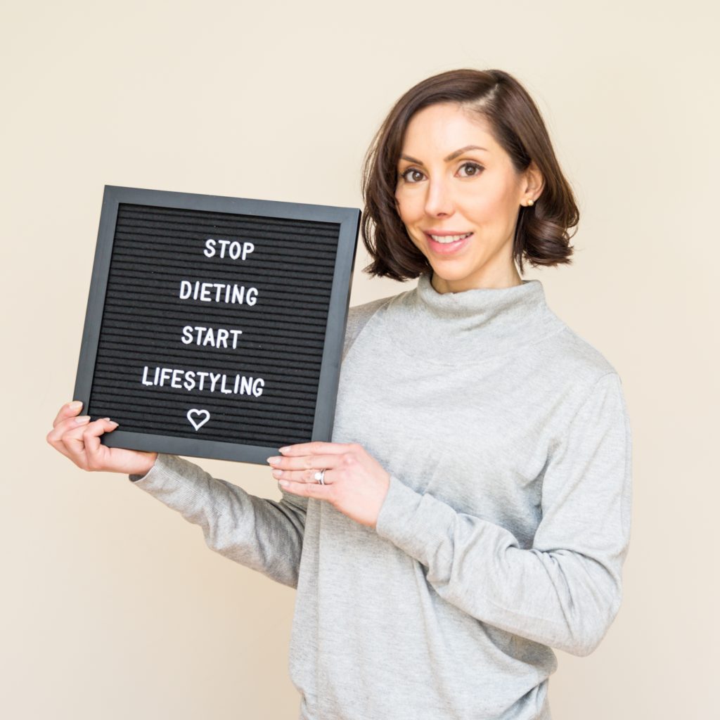 Lisa Spriet Holding a Sign for "Stop Dieting, Start Lifestyling"